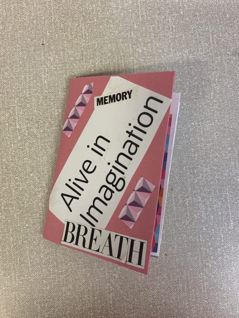A pink and white zine with the phrases: "Alive in Imagination", "Memory" and "Breath" and a geometric design on the cover.