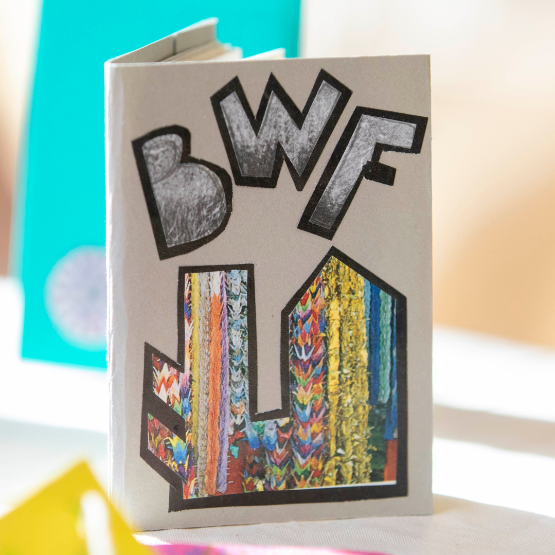 A small zine with the letters "BWF" and colourful patterns.